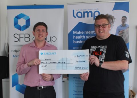 SFB's Matt Wilkes presenting LAMP with a cheque