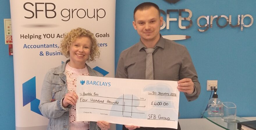 SFB Group Client Manager Jack Riggs presenting Bumble Bea treasurer Helen with a cheque